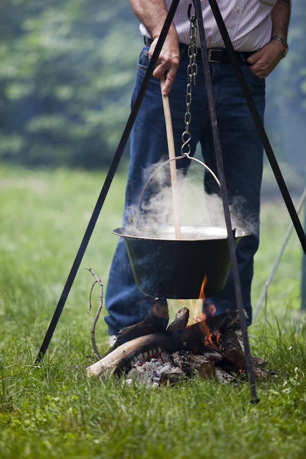 Cooking food using a campfire. Cooking food using a campfire