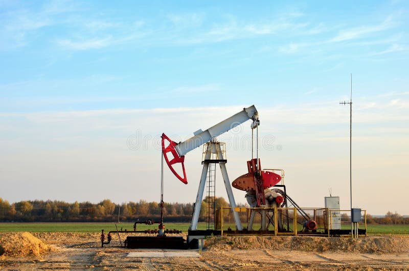 Oil drilling derricks at desert oilfield for fossil fuels output and crude oil production from the ground. Oil drill rig and pump royalty free stock photography Oil drilling derricks at desert oilfield for fossil fuels output and crude oil production from the ground. Oil drill rig and pump royalty free stock photography