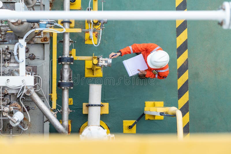 Oil and gas industry activity, operator check and inspect oil pump differential gauge and pressure transmitter as daily log sheet royalty free stock photography Oil and gas industry activity, operator check and inspect oil pump differential gauge and pressure transmitter as daily log sheet royalty free stock photography