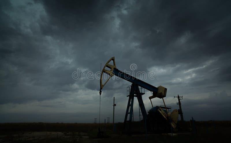 Oil and gas rig profiled on storm clouds