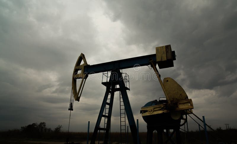 Oil and gas rig profiled on storm clouds