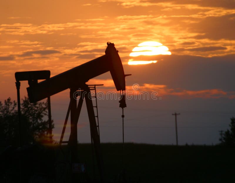 Oil pump jack at sunset stock images Oil pump jack at sunset stock images