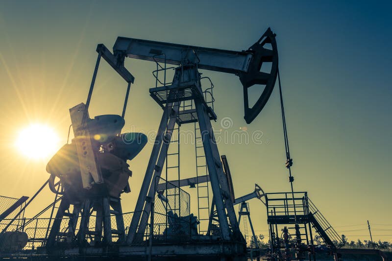 Oil pump rig. Oil and gas production. Oilfield site. Pump Jack are running. Drilling derricks for fossil fuels output