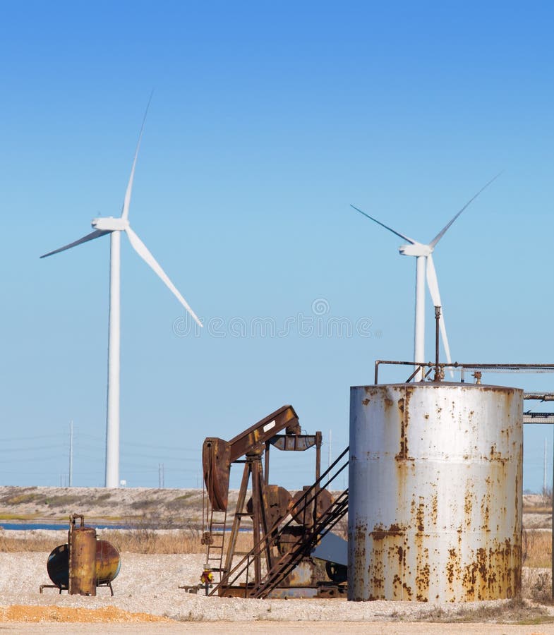 Old Oil Pump and Wind Turbines in the background in Texas. Texas wind energy turbines stock images, royalty-free photos and pictures