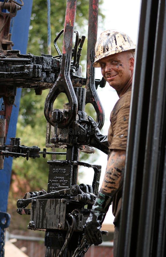 An oil worker on the rigs, covered in oil. This was an oil reabandonment project in Huntington Beach CA. An oil worker on the rigs, covered in oil. This was an oil reabandonment project in Huntington Beach CA.