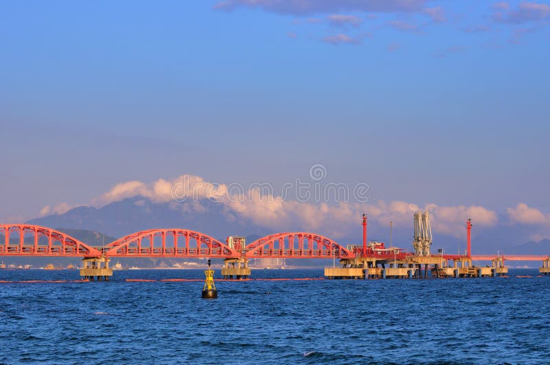 Oil transfer pipe line on sea under sunset light