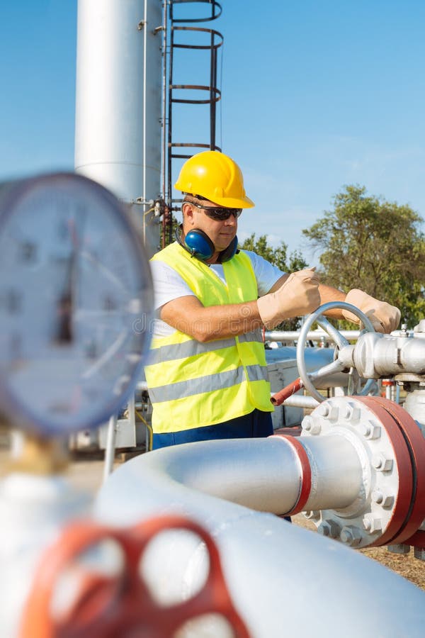 Oil worker in industrial oil stock photography
