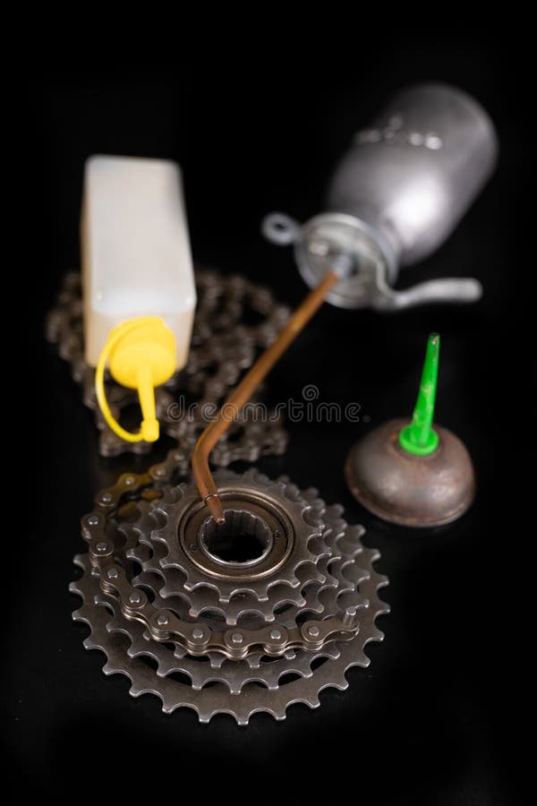 Oiling the Bicycle Chain with an Oil Can on the Table