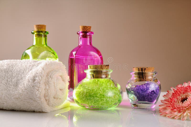 Oils and Bath Salts on White Glass Table Dimly Light Stock Image