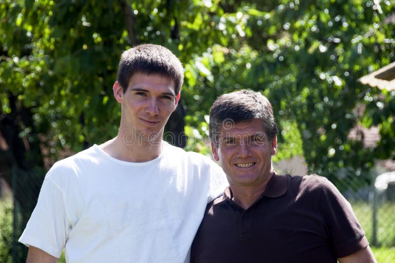 Smiling father and teenager son in the garden. Smiling father and teenager son in the garden