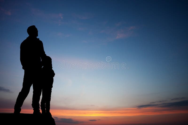 Silhouette of father and son in sunset sky. Silhouette of father and son in sunset sky