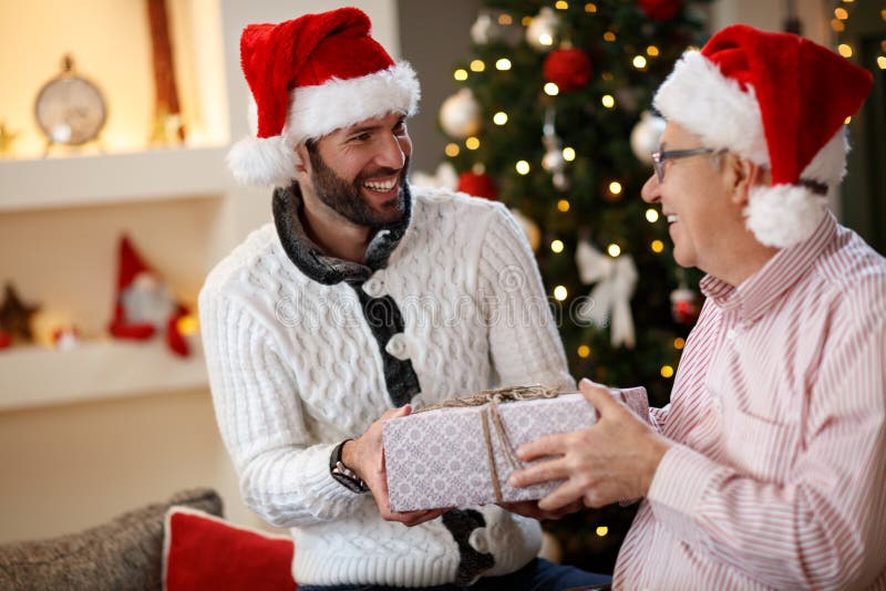 Father and son together celebrate Christmas at home. Father and son together celebrate Christmas at home