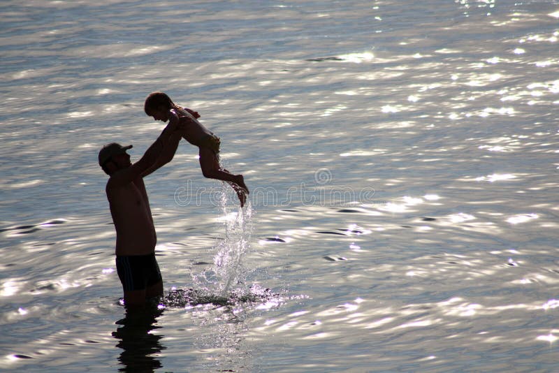 Father play with her son in sea. Father play with her son in sea