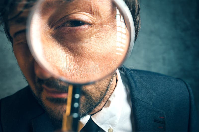 Enlarged eye of tax inspector looking through magnifying glass, inspecting offshore company financial papers, documents and reports. Enlarged eye of tax inspector looking through magnifying glass, inspecting offshore company financial papers, documents and reports.