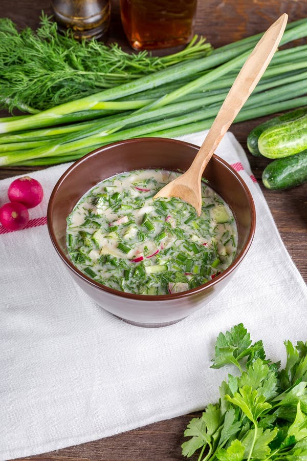 Okroshka, okroshka na drewnianym stole, zimna polewka, Rosyjska krajowa kuchnia, wiosen cebule, lata jedzenie