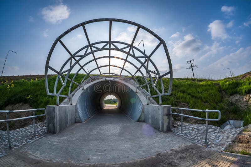 Round tunnel footpath on blue sky background. Round tunnel footpath on blue sky background.