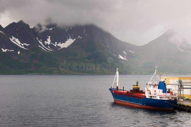 Bulk ship moored near a wharehouse in Oksfjord, Norway