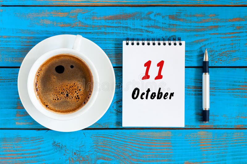 October 11th. Day 11 of october month, calendar on workbook with coffee cup at student workplace background. Autumn time. October 11th. Day 11 of october month, calendar on workbook with coffee cup at student workplace background. Autumn time.