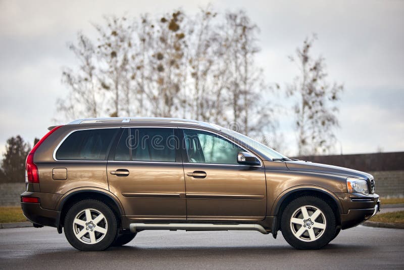 Berlin - October 2021:: Volvo XC90 2.5 1st generation Twilight Bronze 2002-20014 restyling 4WD 4wheel 4x4 SUV at spring forest road right side view in the evening under cloudy sky, with copyspace. Berlin - October 2021:: Volvo XC90 2.5 1st generation Twilight Bronze 2002-20014 restyling 4WD 4wheel 4x4 SUV at spring forest road right side view in the evening under cloudy sky, with copyspace.