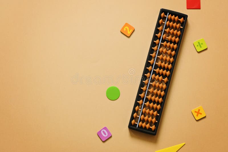 Old Abacus with Numbers on Beige Sand Background . Mental Mathematics
