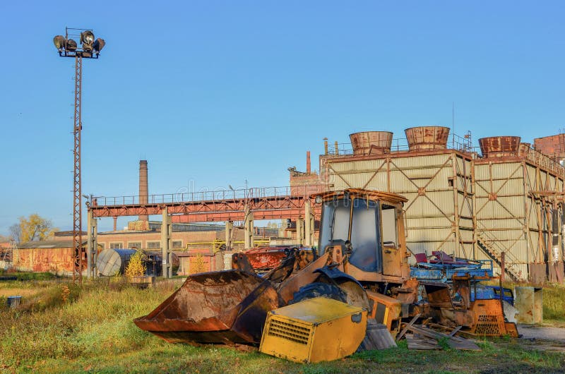 Old abandoned rusty loader with a ladle on the background royalty free stock photography
