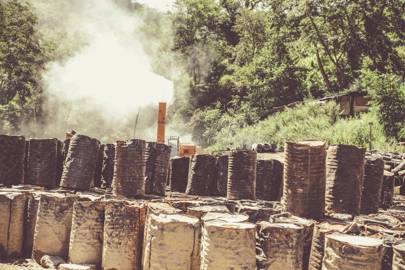 Old abandoned smoking chemical fuel barrels near Thimphu, Bhutan