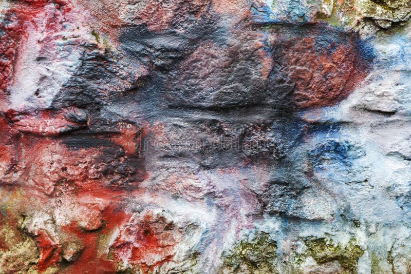 Multi coloured painted stone brick wall background royalty free stock image