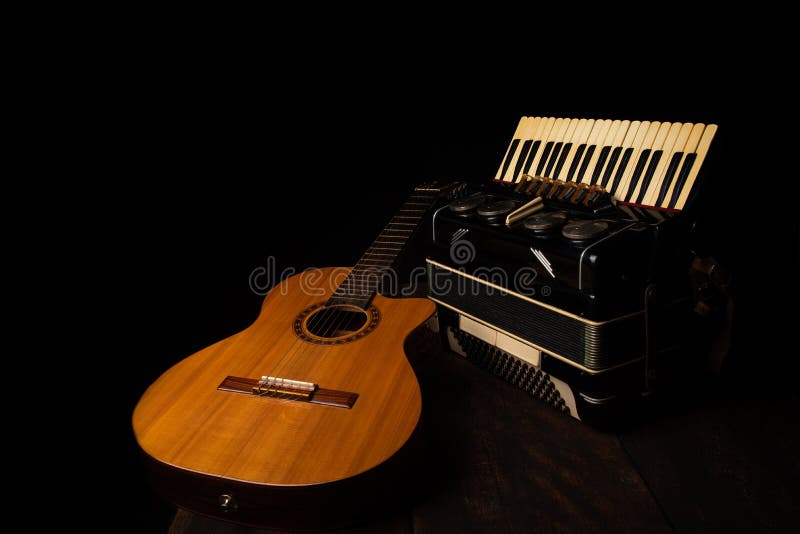 Old Accordion and a Beautiful Guitar Composing a Scene on a Rustic