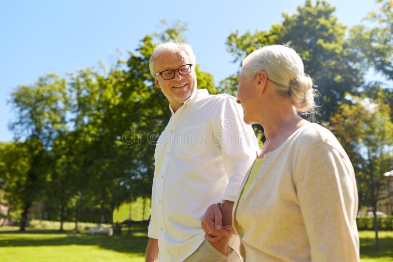 Happy senior couple walking at summer city park royalty free stock images Happy senior couple walking at summer city park royalty free stock images