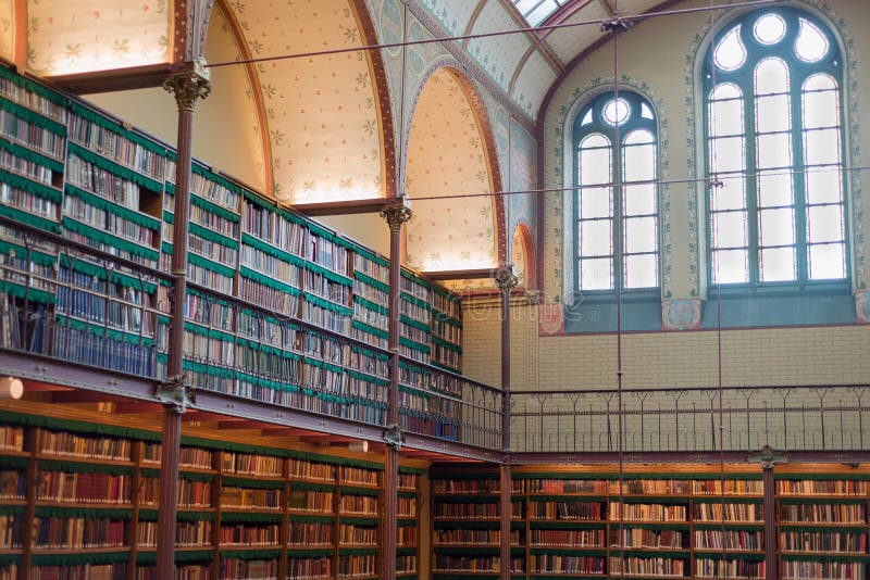 Old ancient library interior, ceiling books, windows, bookshelf stock image