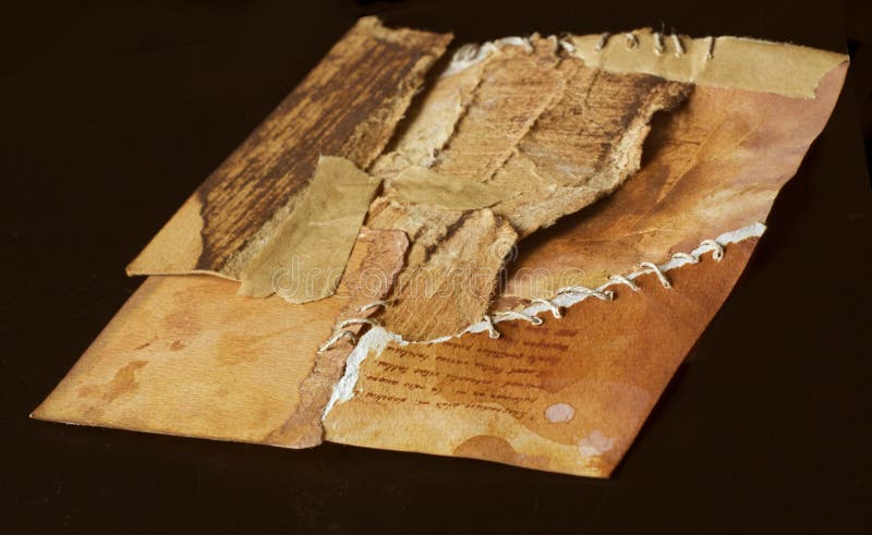 Old ancient paper torn in pieces brought back together again, symbolic concept. Symbolic stock images, royalty-free photos and pictures