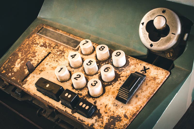 Old antique cash register, adding machines or antique calculate in old convenience store.