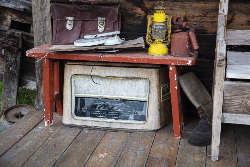 The old antique radio is decaying under the bench stock photo