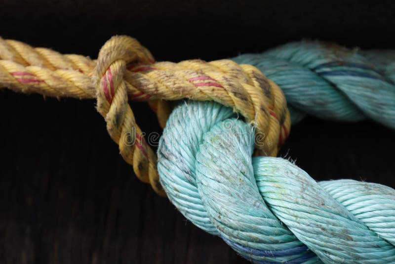 Old Yellow and Aqua Blue Rope Tied in Knot royalty free stock image Old Yellow and Aqua Blue Rope Tied in Knot royalty free stock image