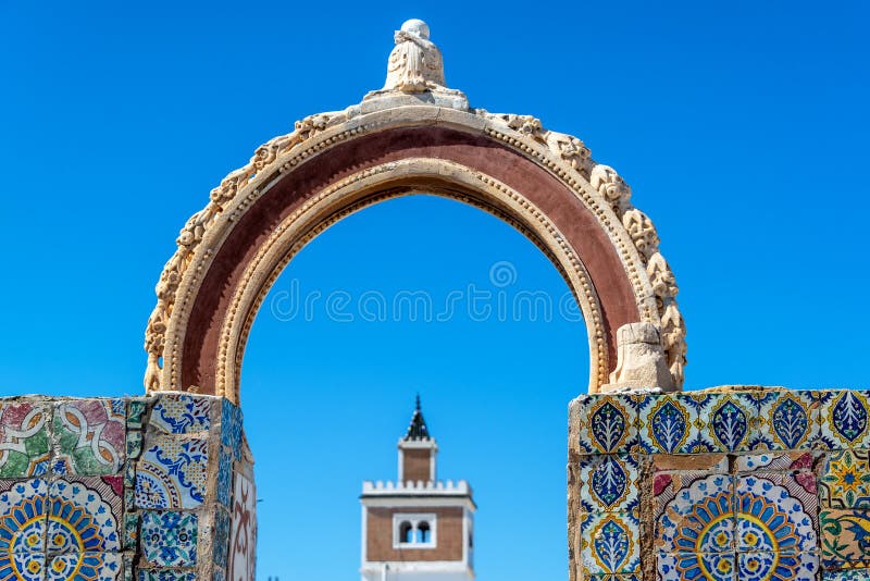 Old historic colorful arch with a mosque in the background in Tunis, Tunisia. Old historic colorful arch with a mosque in the background in Tunis, Tunisia