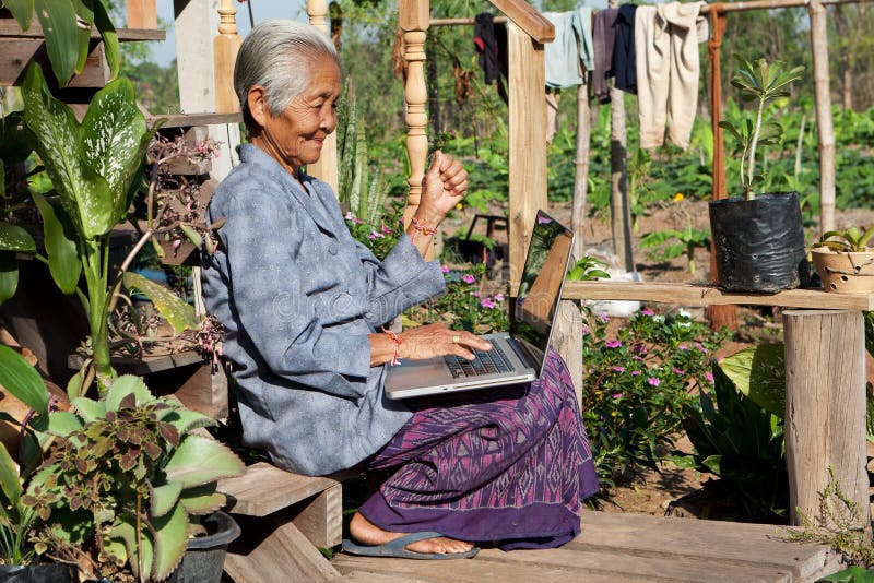 Old asian woman with laptop