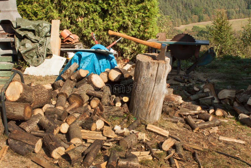 After Ten Years Of Chopping Firewood Old Ax on Log and Firewood. Axe Cut into Wood after Chopping Firewood