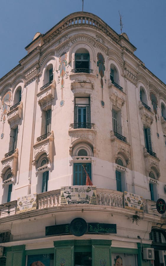 The old beautiful building with colonial-style facades on the streets of downtown Tunis during the hot sunny day in Tunisia