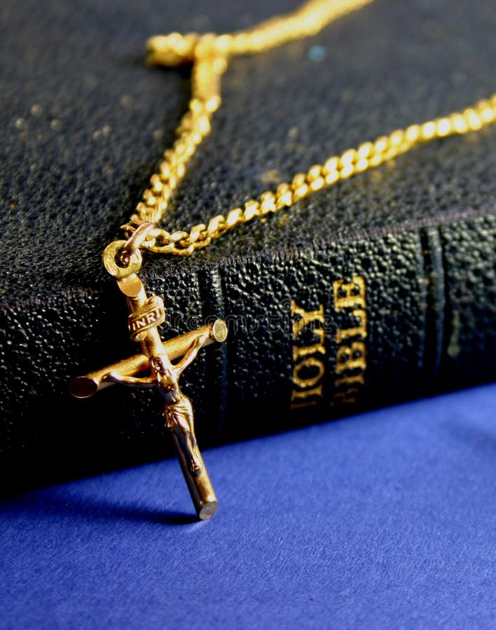 Old bible and gold crucifix on chain. Old bible and gold crucifix on chain