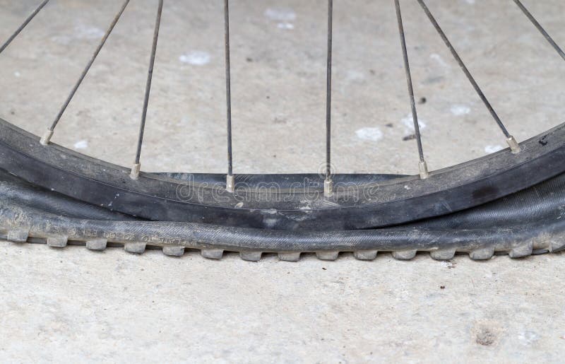 Old Bicycle Wheel with Flat Tyre on Road Stock Image - Image of deflat, biking: