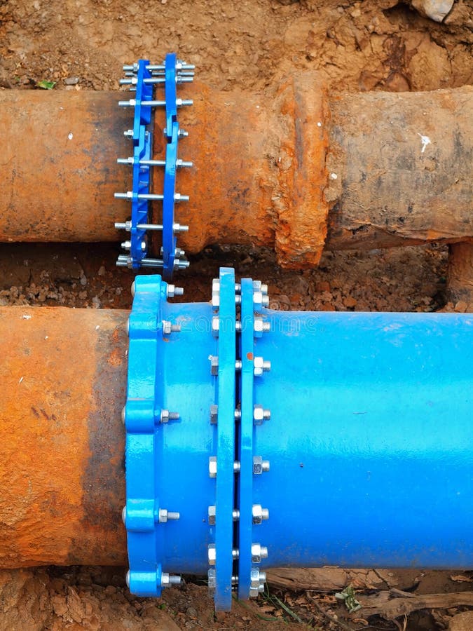 Old big drink water pipes joined with new blue valves and new blue joint members. Finished repaired piping waiting for covering by