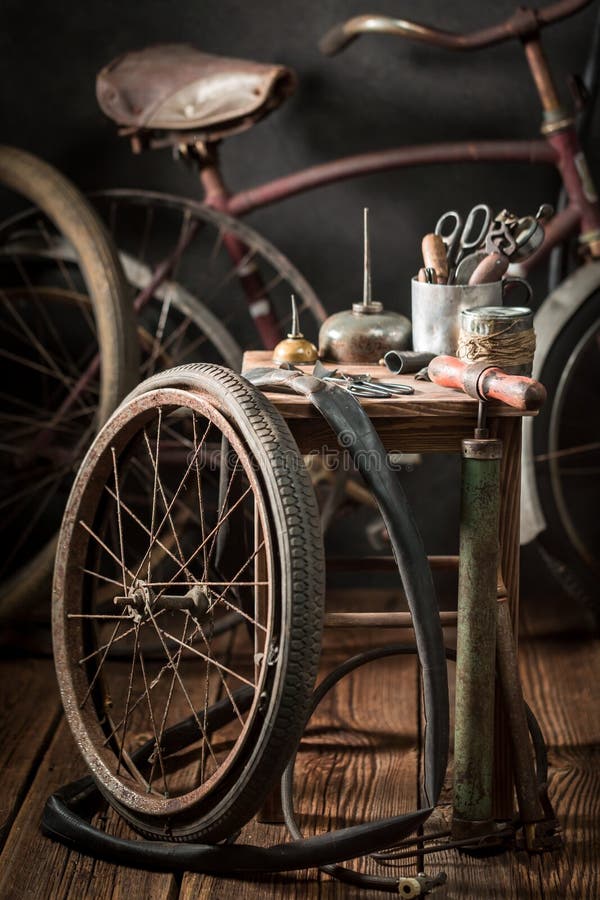 Old bike fix service with wheels, tools, and rubber patch