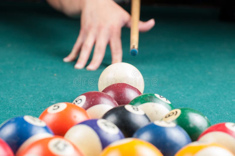 Old billiard balls and stick on a green table. billiard balls isolated on a green background stock photos