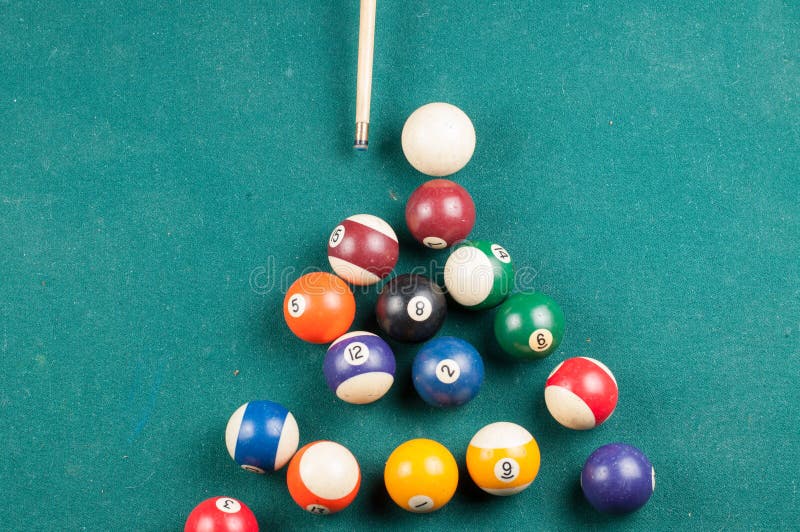 Old Billiard Balls and Stick on a Green Table. Billiard Balls Isolated