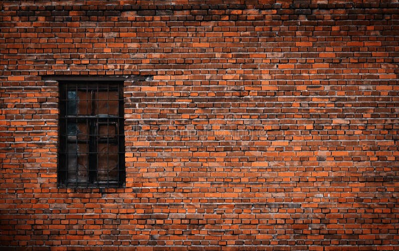 Old Black Brick Wall and Window Locked with Metal Bars Stock Photo