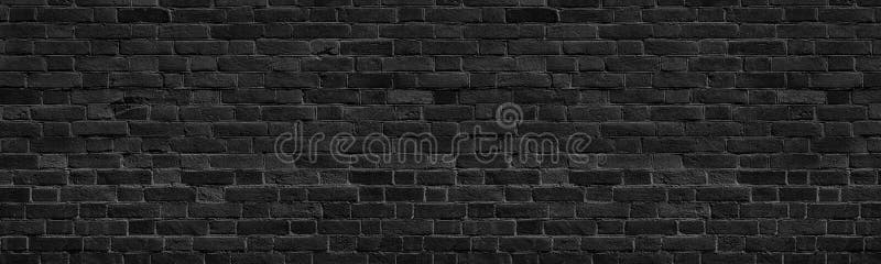 Old black shabby brick wall wide panoramic texture. Dark grey rough masonry. Aged brickwork panorama. Abstract grunge background