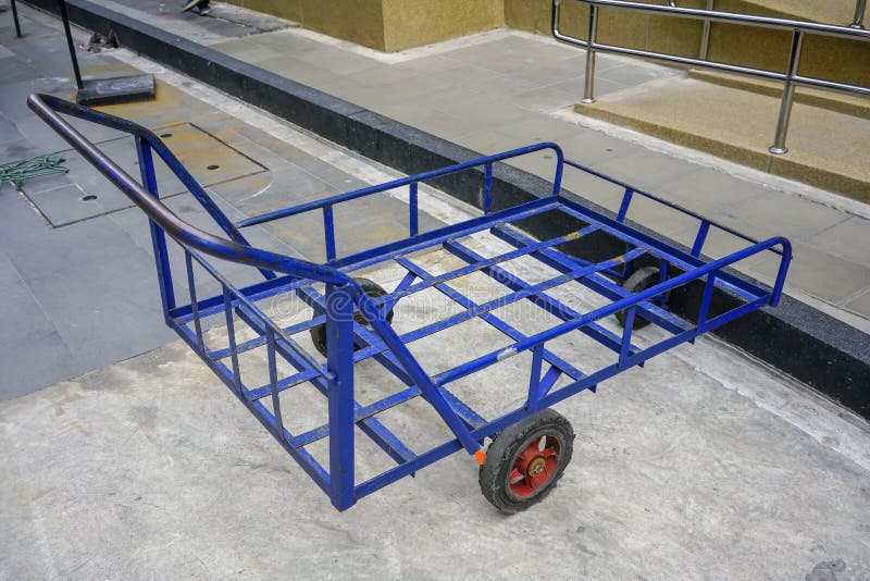 Old blue pull along wagon cart with 3 wheels for heavy duty park royalty free stock image Old blue pull along wagon cart with 3 wheels for heavy duty park royalty free stock image