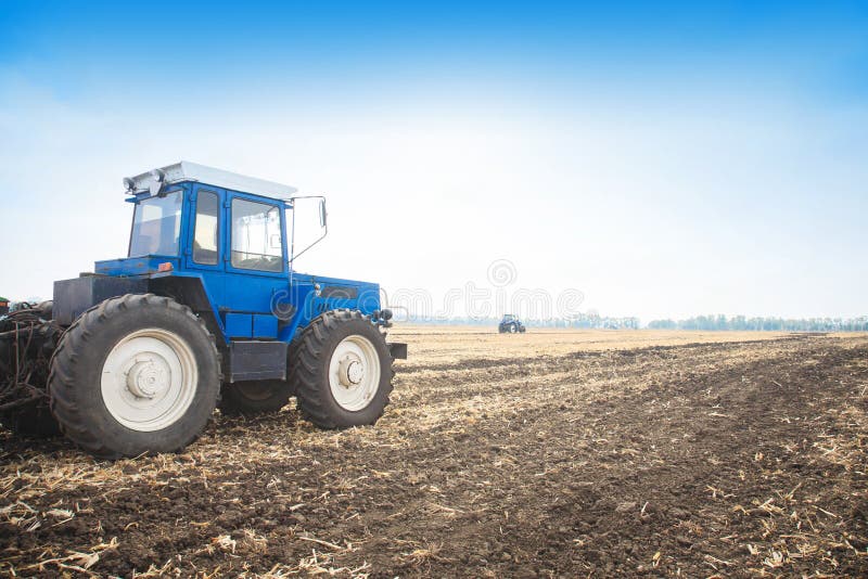 Old Blue Tractor in a Empty Field. Agricultural Machinery, Field Work