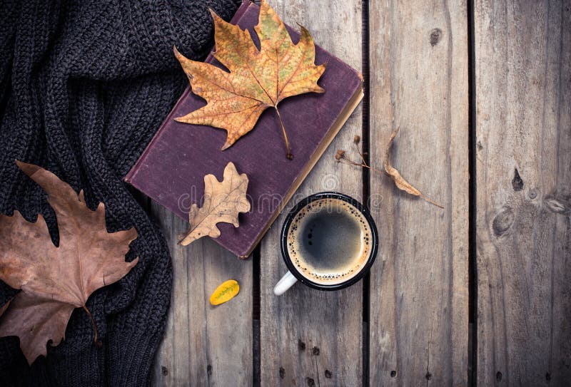 Old book, knitted sweater with autumn leaves and coffee mug royalty free stock image