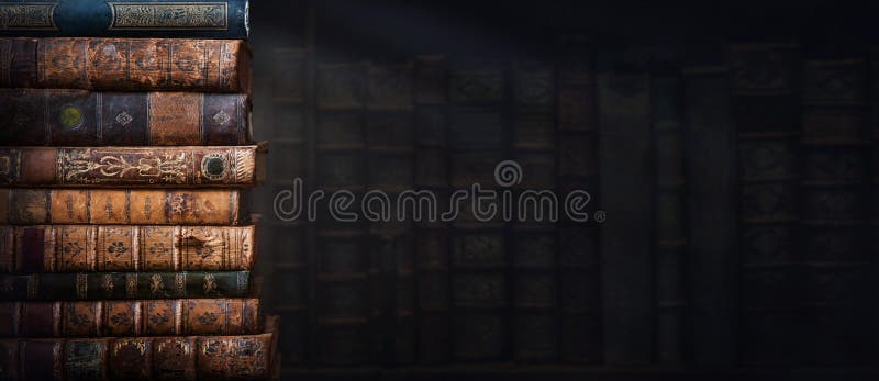 Old books on wooden shelf and ray of light. Bookshelf history theme grunge background. Concept on the theme of history, nostalgia